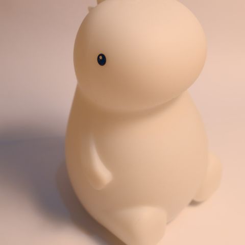 A small night light shaped like a dinosaur